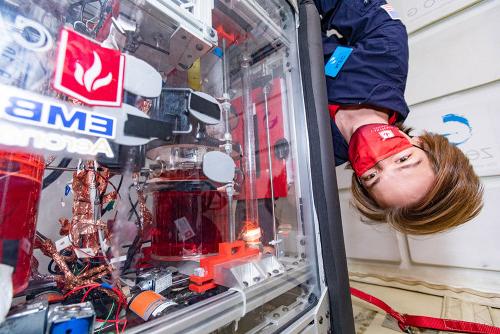 The Microgravity Team study their experiment during their zero-g flight.